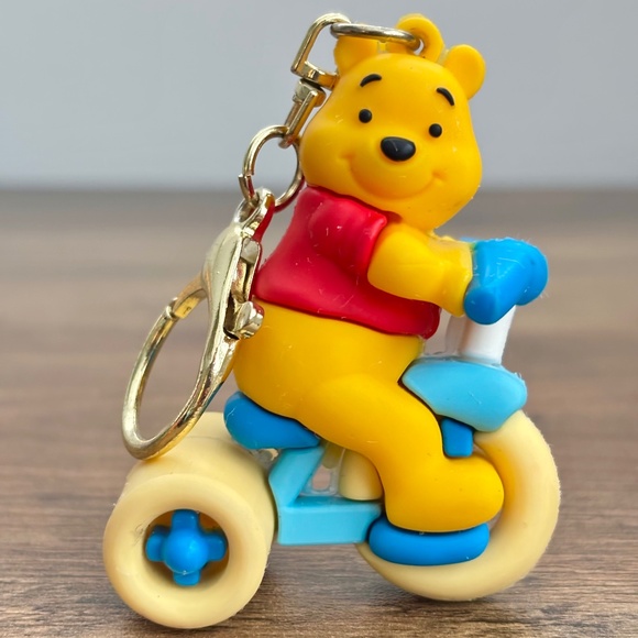 DISNEY Rubber & Metal Keychain Backpack Bag Clip WINNIE THE POOH Riding A Bike - Picture 1 of 9